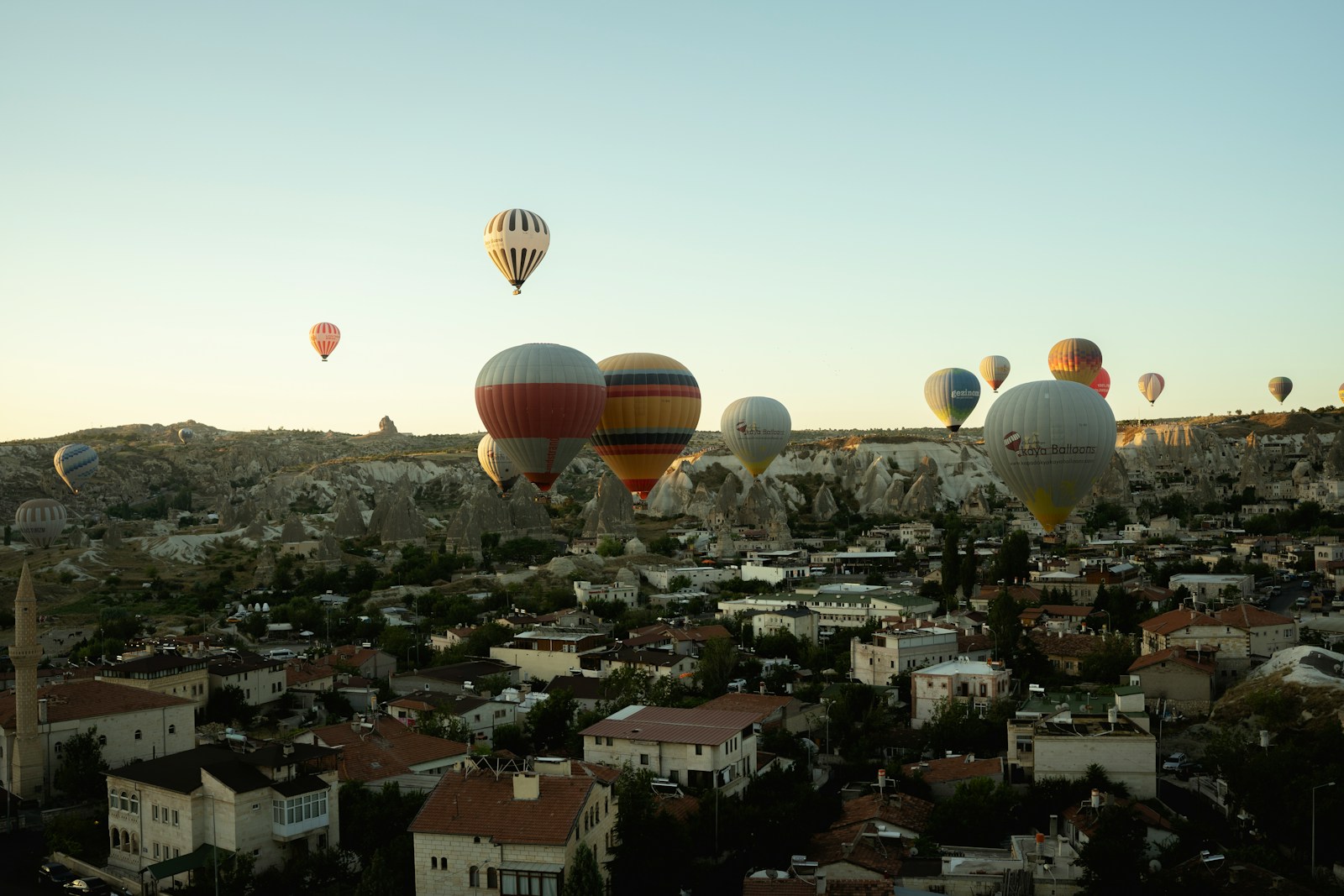 a group of hot air balloons flying over a city